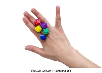 Korean traditional game kit Gonggi. Colourful plastic stones on the back of the player's hand. Isolated on white background. 
