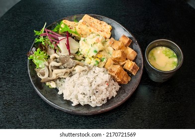 Korean Vegetarian Dosirak, Fried Tofu Vegetarian Bento Box With Vegetables On Rice On Black Table Background