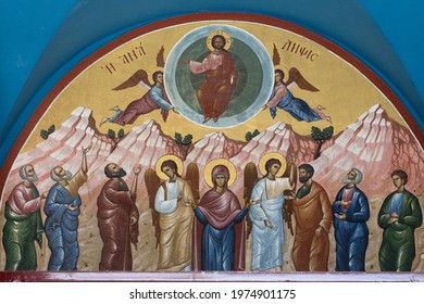 Koropi, East Attica , Greece - 15.05.2021 : Colourful Hagiography of the Ascension of Jesus Christ ,on the facade above the entrance of the church with the same name in Koropi area 