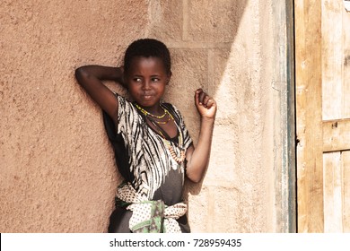 Korr, North Kenya, January 2016. Portrait Of A Cute Little African Girl Posing In Front Of A House. 