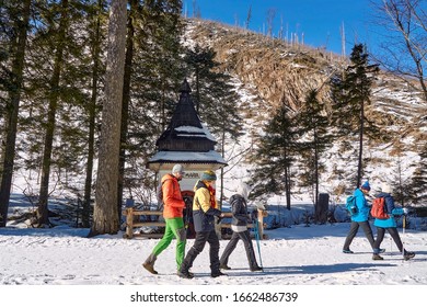 Koscieliska Valley, Poland - Febuary 15, 2020. Tourists Passing By Shrine Of The Outlaws With Ave Maria (Hail Mary) Inscription In Koscieliska Valley Near Zakopane, Poland