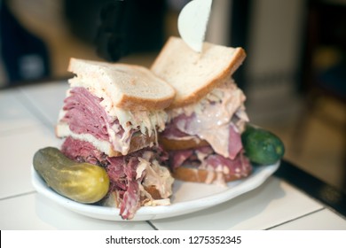 Kosher Deli Combination Sandwich Pastrami Corned Beef Tongue Cole Slaw And Russian Dressing On Seeded Jewish Rye Bread With Garlic And Sour Pickles New York Restaurant Delicatessen