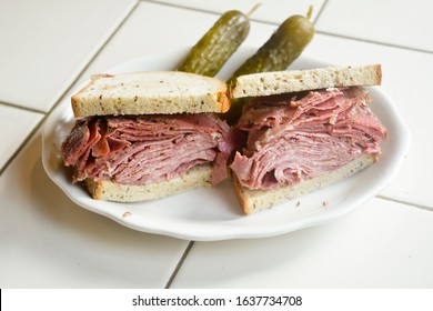 Kosher New York City Deli Corned Beef Tongue Combination Sandwich On Rye Bread With Pickles