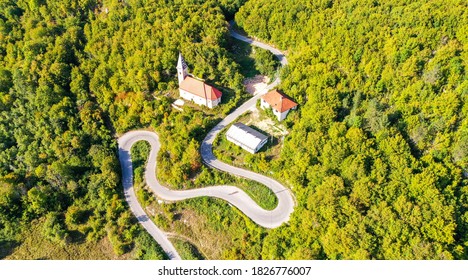 KOSINJ, CROATIA - September 2020 - Aerial View Of Winding Curvy Rural Road Through The Forest And Village