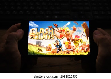 Kostanay, Kazakhstan, November 04, 2021.A man holds a mobile phone with a screensaver of the popular Clash of Clans game