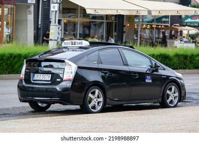 KOSZALIN, POLAND - AUGUST 5, 2022: Toyota Prius Hybrid Taxi Car In Streets Of Koszalin, Poland