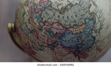 Kota Kinabalu, Malaysia - Jan 26, 2019; Close up shot of vintage globe model with a map of the world over wooden table as background. Selected focus. - Shutterstock ID 1305918982