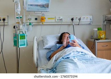 Kota Kinabalu, Sabah, Malaysia - May 30, 2020 : Asian Chinese Female Patient Resting While Playing Smart Phone On The Labour Room After Delivery Newborn Baby In Hospital At Kota Kinabalu, Sabah, Malay