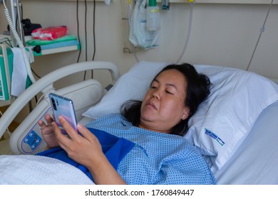 Kota Kinabalu, Sabah, Malaysia - May 30, 2020 : Asian Chinese Female Patient Resting While Playing Smart Phone On The Labour Room After Delivery Newborn Baby In Hospital At Kota Kinabalu, Sabah, Malay