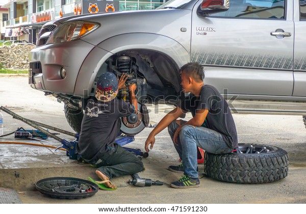 Kota\
Kinabalu,Sabah-Aug 11,2016:The car mechanics garage doing\
maintenance car shock absorber at Kota Kinabalu,Sabah.Shock\
absorbers can also leak as they are filled with\
oil.