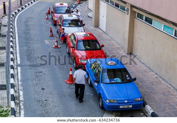 Kota Kinabalu,Sabah-June 18,2016:Taxi cars\
waiting for the passengers at Kota Kinabalu,Sabah.The Uber,creates\
a win for consumers because the competition with taxi services\
creates better services.