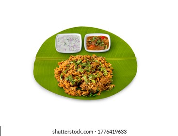 Kothu Parotta, Tamil Nadu Famous Street Food Kothu Parotta With Chicken Gravy And Onion Curd Raita / Onion Pachadi, Curried Shredded Indian Flat Bread, Veechu Parotta Served On Banana Leaf