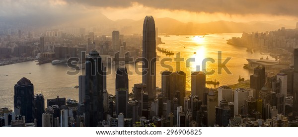 Kowloon Bay is given a golden glow by the sun as it\
rises over Hong Kong.