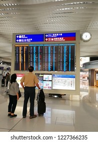 Kowloon Hongkong, October 4 2018, Older Couple Checking Time At Departures Board At Hongkong International Airport