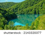 Kozjak lake with ferry boats overlook on Plitvice Lakes National Park of Croatia. Natural forest park with lakes and waterfalls in Lika region. UNESCO World Heritage of Croatia named Plitvicka Jezera