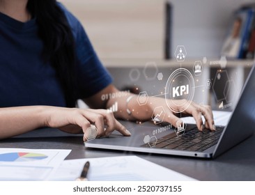 KPI, Analyzing Key Performance Indicators. Businessman using laptop to analyze key performance indicators (KPIs) displayed as holographic icons. operations, sales.