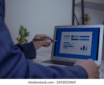 KPI dashboard data analysis to evaluate business performance. Businessman using Stylus pen to analyze KPI performance dashboard. Data analysis concept, business analytics, metrics tracking and growth.