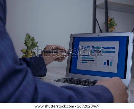 KPI dashboard data analysis to evaluate business performance. Businessman using Stylus pen to analyze KPI performance dashboard. Data analysis concept, business analytics, metrics tracking and growth.