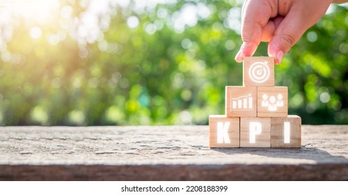 KPI Key Performance Indicator Business And Industrial Analysis Concept, Wooden Block With KPI Icon On Virtual Screen.
