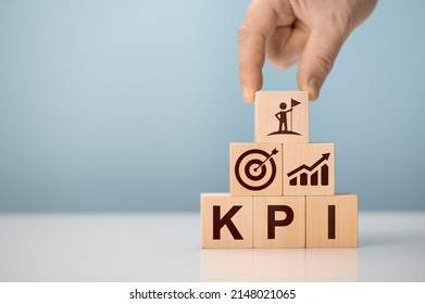 KPI - Key Performance Indicator. Businessman holds cube with KPI icon, KPI key performance indicator increase optimisation business. Business planning and measure success, target achievement. - Shutterstock ID 2148021065