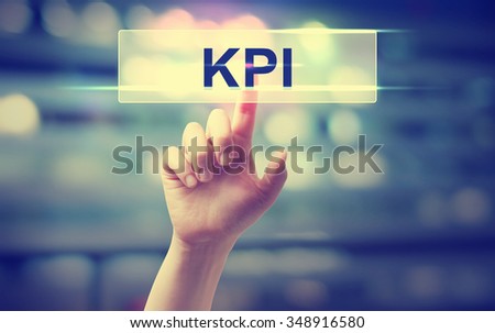 KPI - Key Performance indicator concept with hand pressing a button on blurred abstract background