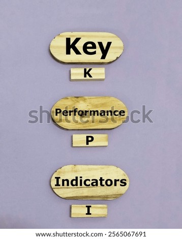 KPI or Key Performance Indicator wording on wooden pieces. Concept of business goals, performance results, and indicators