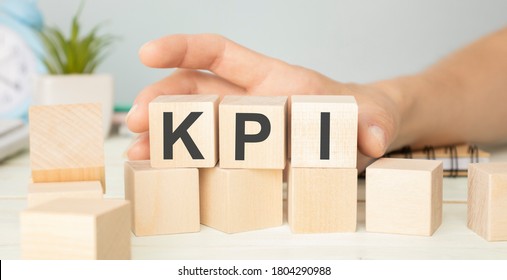 KPI - wooden blocks with letters, key performance indicator KPI concept, top view on white background