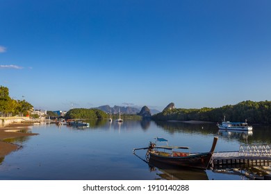 KRABI, THAILAND - JANUARY 23, 2020 - Beautiful natural view of boats, pier, mangrove forest and Khao Khanab Nam mountain at Krabi River, Krabi, Thailand.