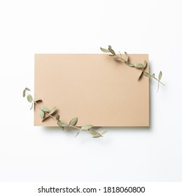 Kraft Brown Memo Pad, Empty Paper With Eucalyptus Leaves On White Background. Top View, Copy Space