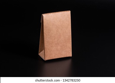 Kraft Cardboard Box On A Black Background, Moke Up
