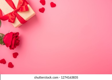 Kraft Gift box with beautiful red ribbon and rose, concept of Valentine's, anniversary, mother's day and birthday greeting, copyspace, topview.