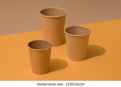 Kraft Paper Eco Coffee Cup On Orange And Brown Background With Copy Space. Sustainable Food Packaging Concept, Mockup