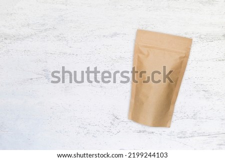 Kraft paper zipper pouch on white wooden background, eco style packaging, brown kraft paper bag Foto d'archivio © 