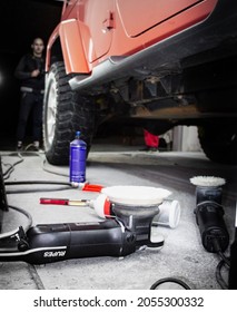 Kragujevac, Serbia. 09.28.2021. Indoor Car Photoshoot, Orange Jeep Wrangler In Selective Focus- Jeep In Car Detailing Studio With Polishing Products In Selective Focus, Blurry Background.