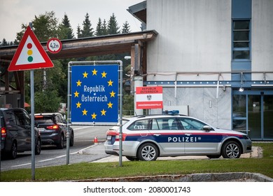 KRAINBERG, AUSTRIA - SEPTEMBER 13, 2021: Austrian Bundespolizei Police Car Controlling People During Coronavirus Covid 19 Crisis At The Austrian Slovenian Border Crossing With EU Border Sign In Front