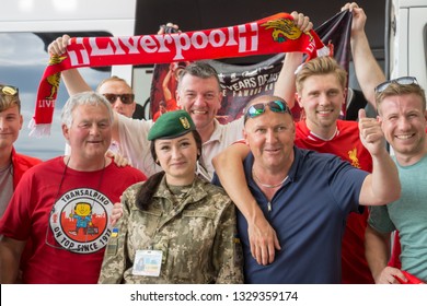 Krakovets, UKRAINE - May 25, 2018: Friendly English Football Fans Of The Club Liverpool Are Photographed With Ukrainian Border Guards And Show Club Symbols Before The 2018 UEFA Champions League Final