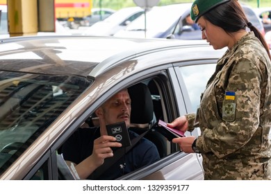 Krakovets, UKRAINE - May 25, 2018: Ukrainian Girl Border Guard Checks Documents During The Border Control Of One Of The English Football Fans Before The 2018 UEFA Champions League Final In Kiev