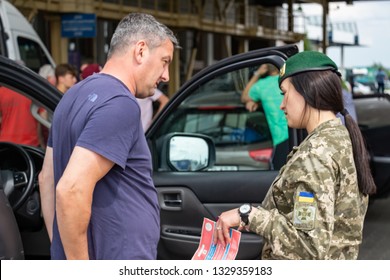 Krakovets, UKRAINE - May 25, 2018: Ukrainian Border Guard Girl Talks To One Of The English Football Fans Near The Car During Border Control Before The 2018 UEFA Champions League Final In Kiev