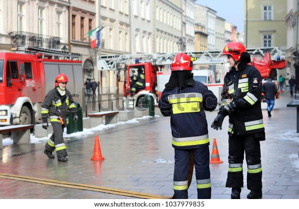 Krakow, Grodska \
street, Poland - 02.26.2018: Exercises fire brigade in the old part\
of the city in the winter. Elimination of fire and natural\
disasters. Emergency response\
service.