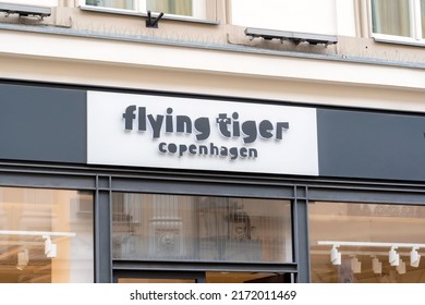 Krakow, Malopolska, Poland - April 2022: Flying Tiger Copenhagen Brand Store Building Front Signage Logo, Sign Up Close, Detail, Shop Name Closeup, Nobody, No People. Front View, Simple Frontal Shot