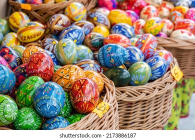 Krakow, Malopolska, Poland - April 2022: Group of colorful handmade Easter eggs in a few baskets, set of handcrafted traditional Polish pisanki, group of objects, detail, closeup, nobody