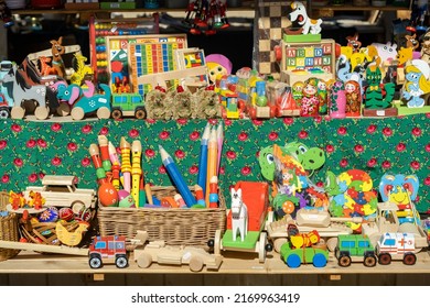 Krakow, Malopolska, Poland - May 2022: Krakow, Poland, Lots Of Colorful Eco Wooden Toys Sold On A Local Festival Market, Large Group Of Objects, Nobody. Variety Of Different Traditional Toys On Sale 