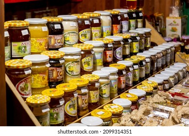 Krakow, Malopolska, Poland - November 2021: Lots of different Polish branded honey glass jars, object group, shop, sweet traditional organic products variety, large selection, market stall, nobody