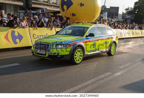KRAKOW, POLAND - AUGUST 15,\
2021: Ambulance car, official medical care during 78. Tour de\
Pologne cycling stage race. LukTrans medical transport Audi in\
Kraków.