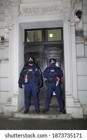 Krakow, Poland - December 13 2020: Tow Policemen With Tear Gas Block To Secure Entrance To Police Station In Lubicz Street In Krakow, Called White Little House, During Anti-government Demonstration 