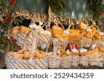 Krakow, Poland - December 5, 2023: Traditional Poland street food oscypek is a grilled cheese of salted sheep milk with different ingredients as bacon or jams. Basket of oscypek on Christmas market