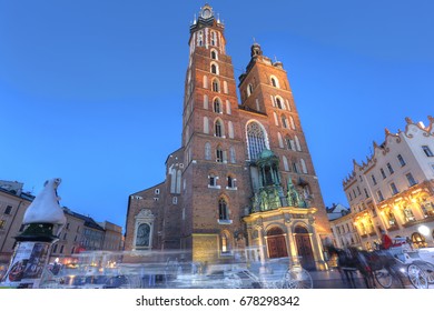 KRAKOW, POLAND - JUL 3: View Of Kosciol Mariacki In Market Square On Jul 3, 2017 In Krakow, Poland. Church Of Our Lady Assumed Into Heaven Is One Of The Best Examples Of Polish Gothic Architecture.