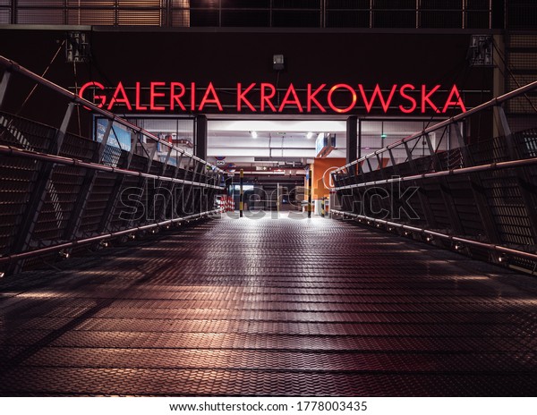 KRAKOW, POLAND - JULY 07, 2020: Galeria Krakowska\
shopping mall in central Krakow by night. Entrance from a outdoor\
car park.