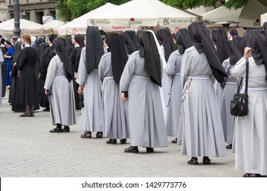 Krakow, Poland - June 20, 2019: A Large Group Of Nuns Seen From The Back During The Feast Of Corpus Christi Procession. Convent, Gathering, Sisterhood Concept