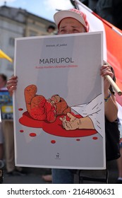 Krakow, Poland - June 5 2022: Poster With Drawing Of Dirty Of Blood Teddy Bear And Dead Child Hand And Slogan MARIUPOL  RUSSIA MURDERS UKRAINIAN CHILDREN Holds By Protester In Teh Street